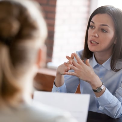 Businesswoman speaking to people at business negotiations