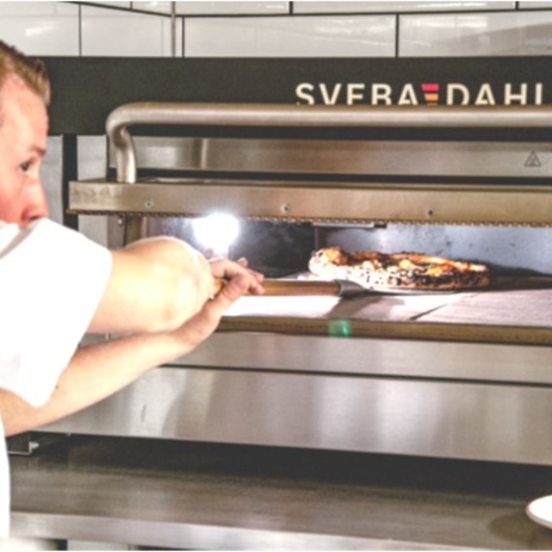 Baker is using a Sveba Dahlen Pizza oven