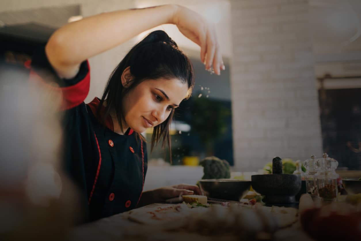 Chef making pizza in a kitchen